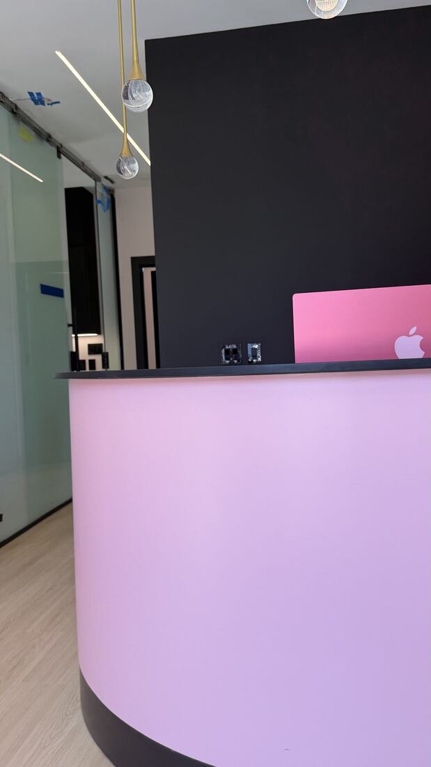 Mirror's signature pink reception desk